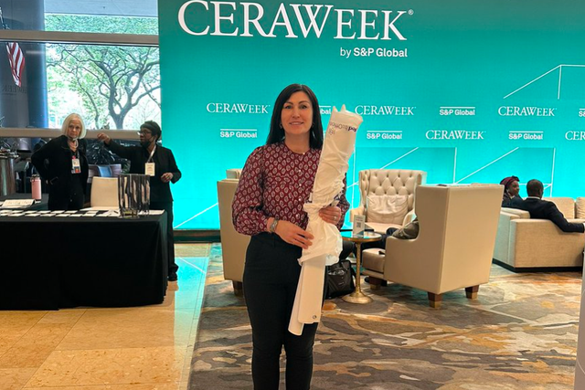 <p>Svitlana Romanko at the entrance to CERA Week in Houston. The environmental lawyer was allowed inside to collect banners she had delivered to the venue and then escorted out, she said</p>