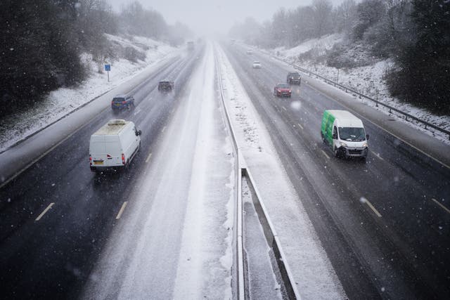 <p>Cars driving through snow on the the M5 motorway near Taunton amid snow cover </p>