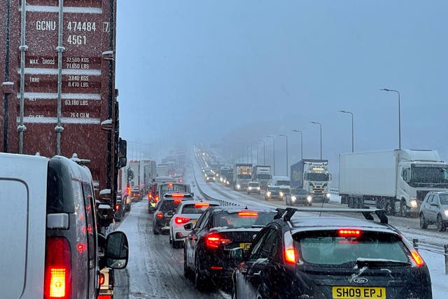 <p>Traffic at a standstill on the M62 motorway near Kirklees, West Yorkshire, due to heavy snow in the area (PA)</p>