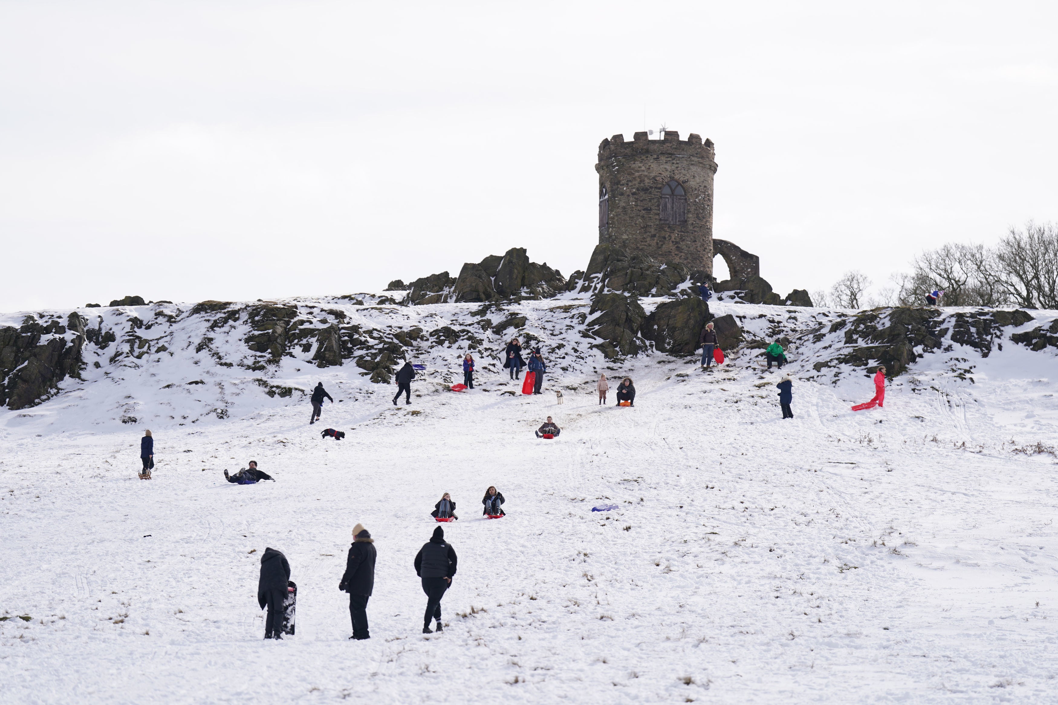 People sledging in the snow at Bradgate park in Leicestershire