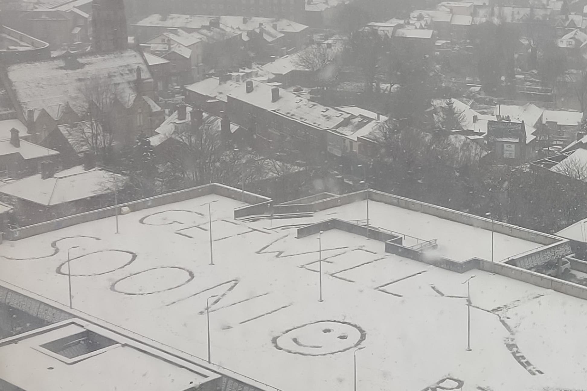 A message written on top of a car park in the snow outside Royal Hallamshire Hospital