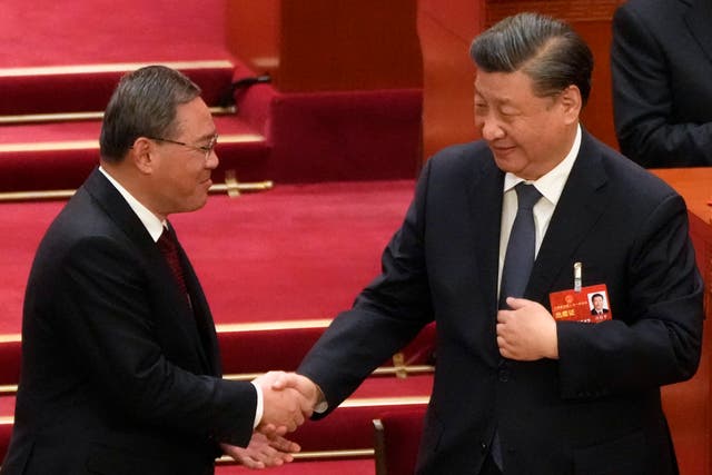 <p>Newly elected premier Li Qiang (left) shakes hands with Chinese president Xi Jinping during a session of China’s National People’s Congress</p>