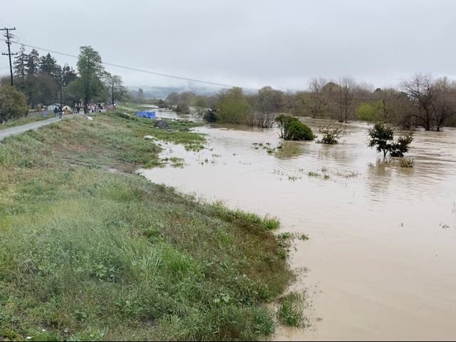 <p>A view shows the overflowing Pajaro River in Pajaro, California, U.S. March 11, 2023 in this screen grab obtained from a social media video. Twitter @BobbieGrennier/via REUTERS</p>