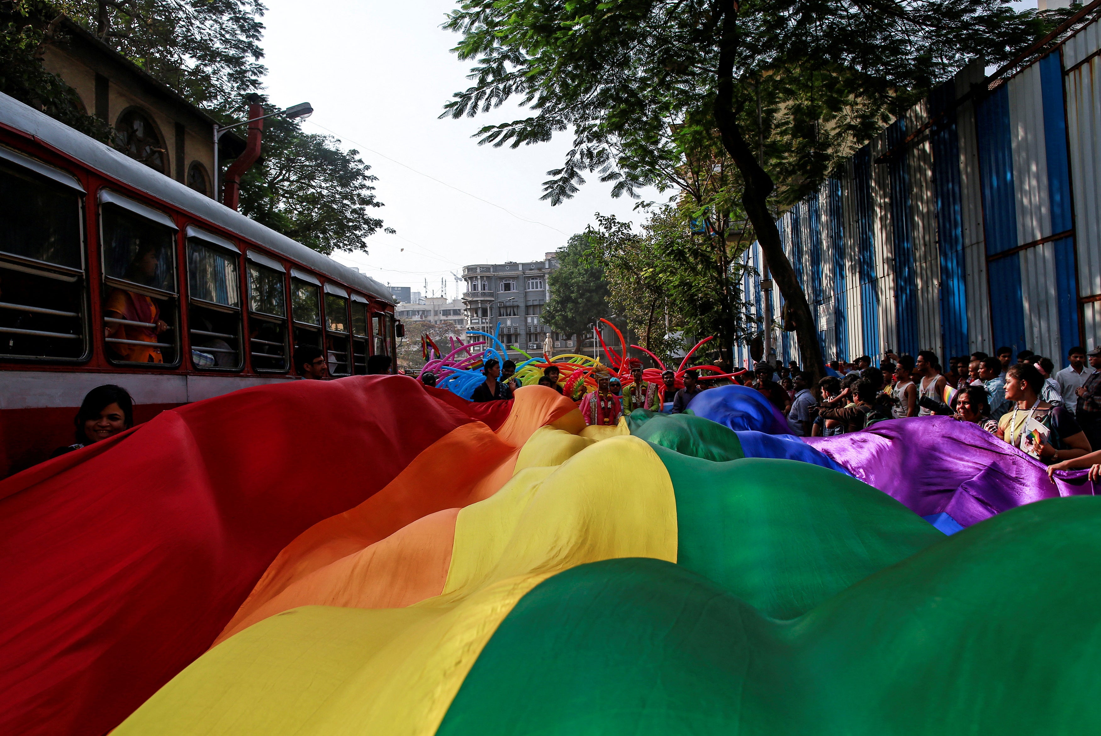 Participants hold a rainbow flag during a gay pride parade in 2015 in Mumbai
