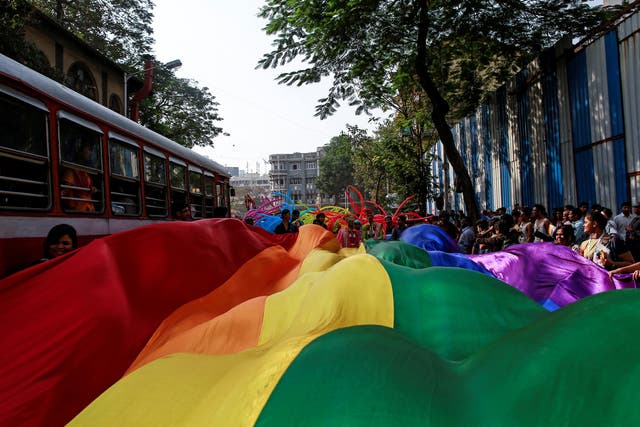 <p>Participants hold a rainbow flag during a gay pride parade in 2015 in Mumbai</p>