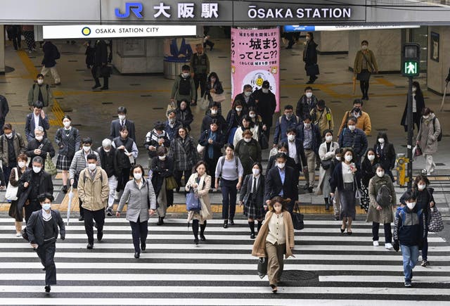 <p>File photo: People walk across an intersection in Osaka, western Japan, Monday, 13 March 2023 </p>