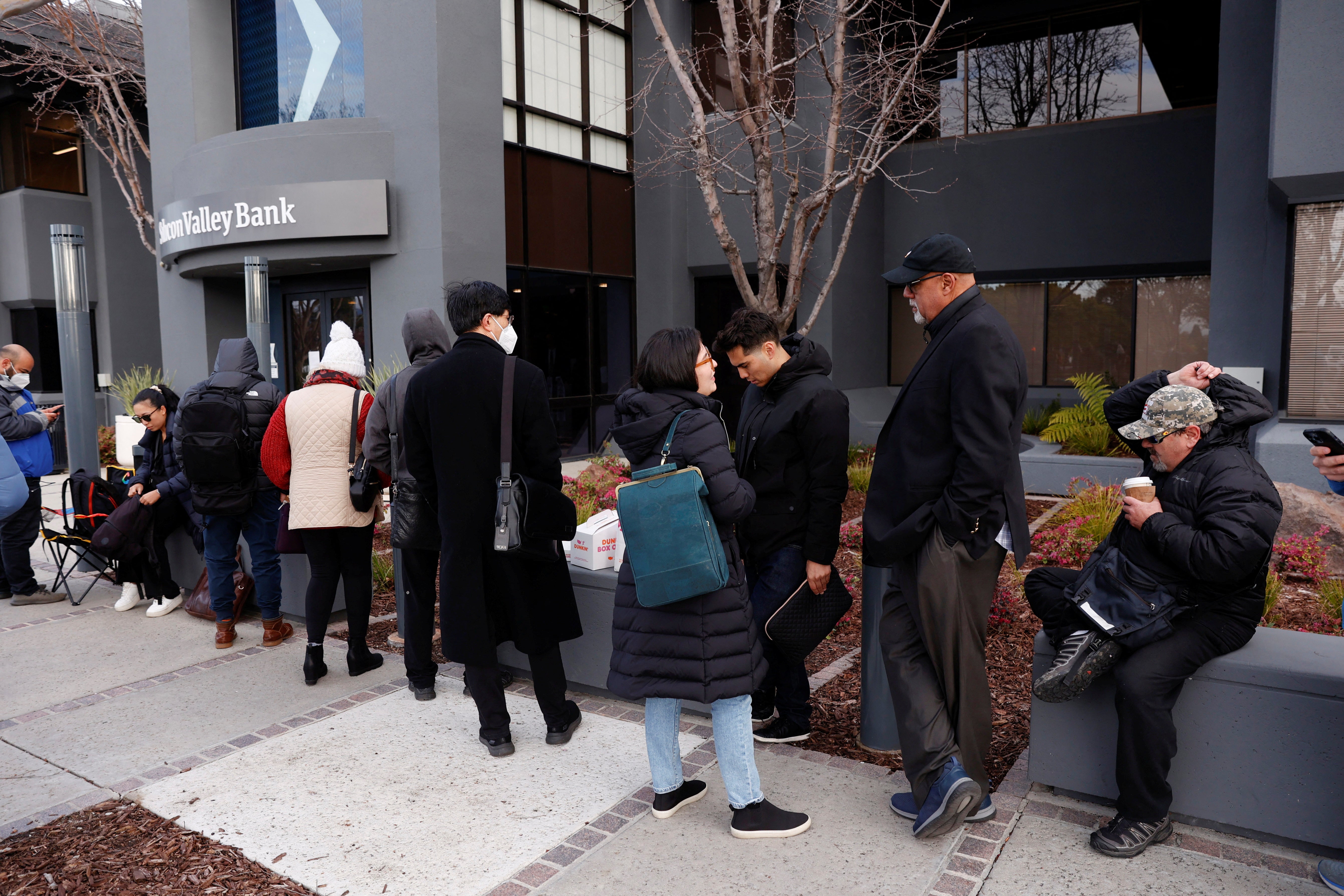 Customers line up outside the Silicon Valley Bank headquarters in Santa Clara, California on Monday