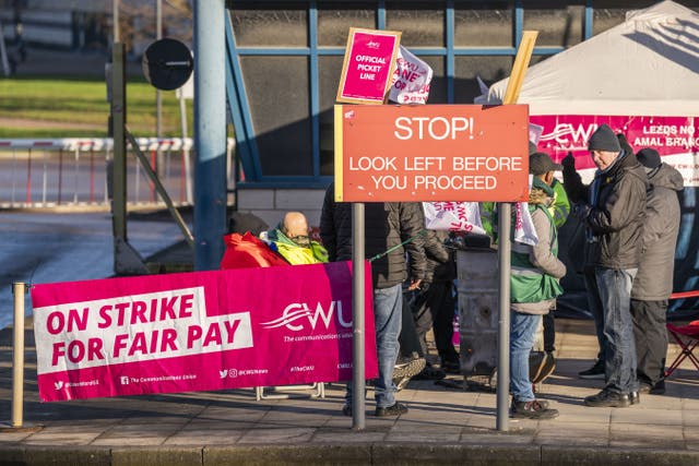 Members of the Communication Workers Union (CWU) on the picket line outside Leeds Mail Centre (Danny Lawson/PA)