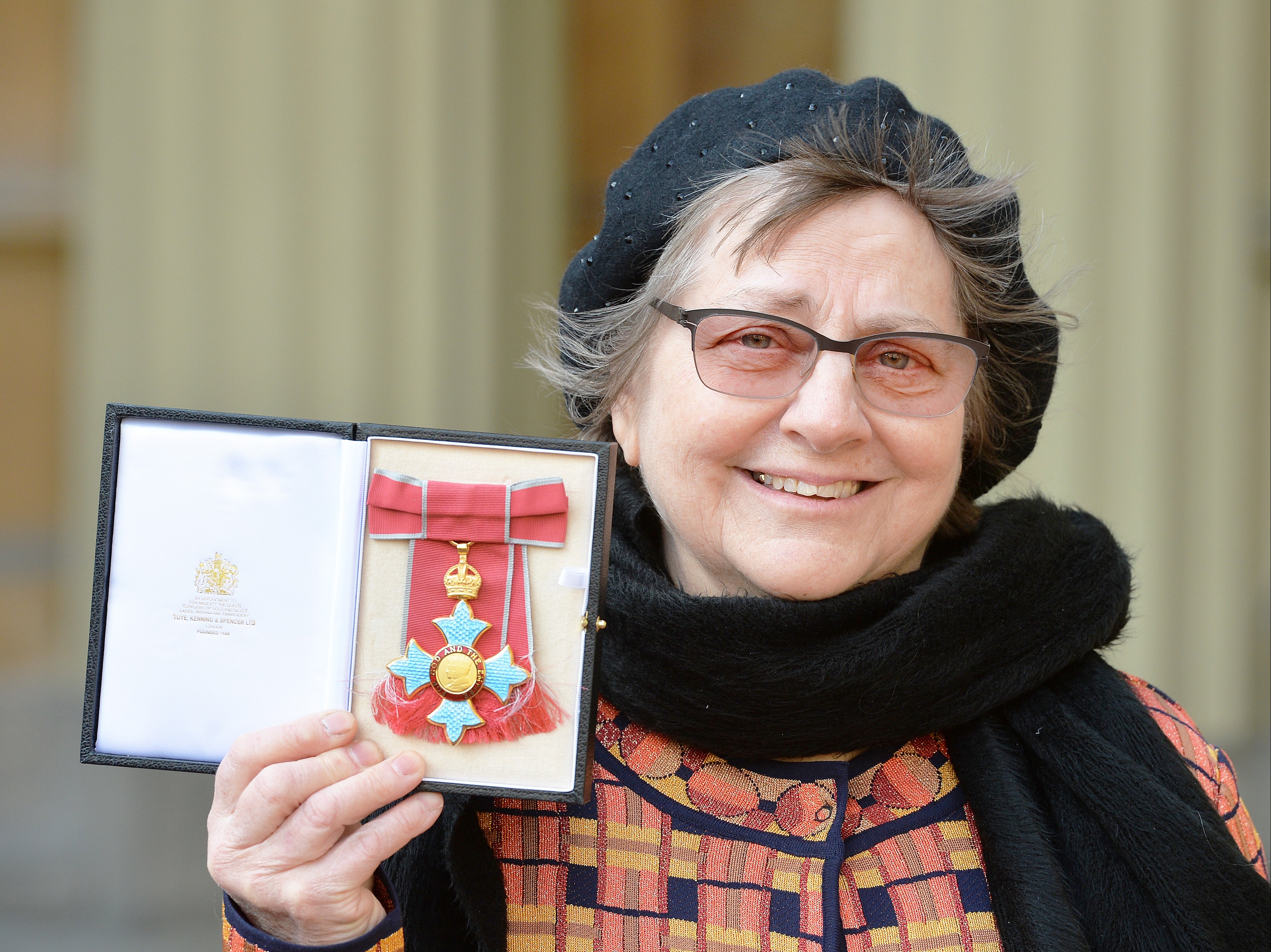 <p>Sculptor Phyllida Barlow holds her CBE medal presented by Prince Charles in 2016</p>