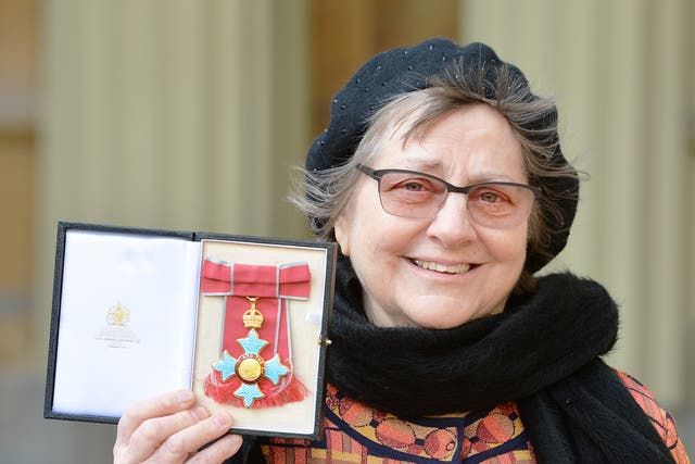 <p>Sculptor Phyllida Barlow holds her CBE medal presented by Prince Charles in 2016</p>