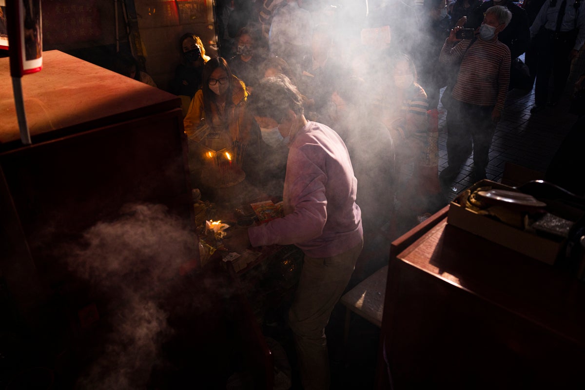 AP PHOTOS: Hong Kong’s ‘villain hitting’ ritual draws crowds