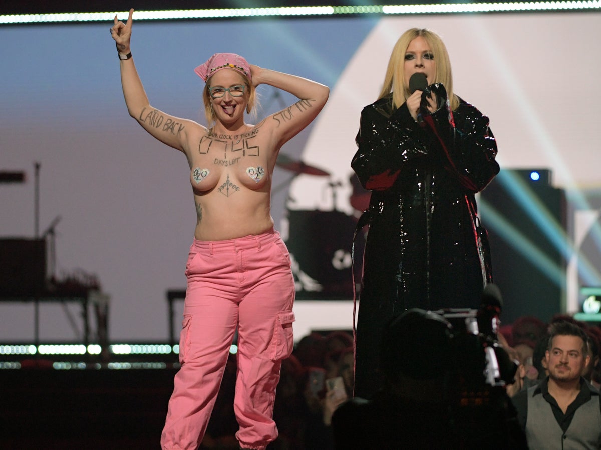 Avril Lavigne orders topless woman off stage during protest at Juno Awards