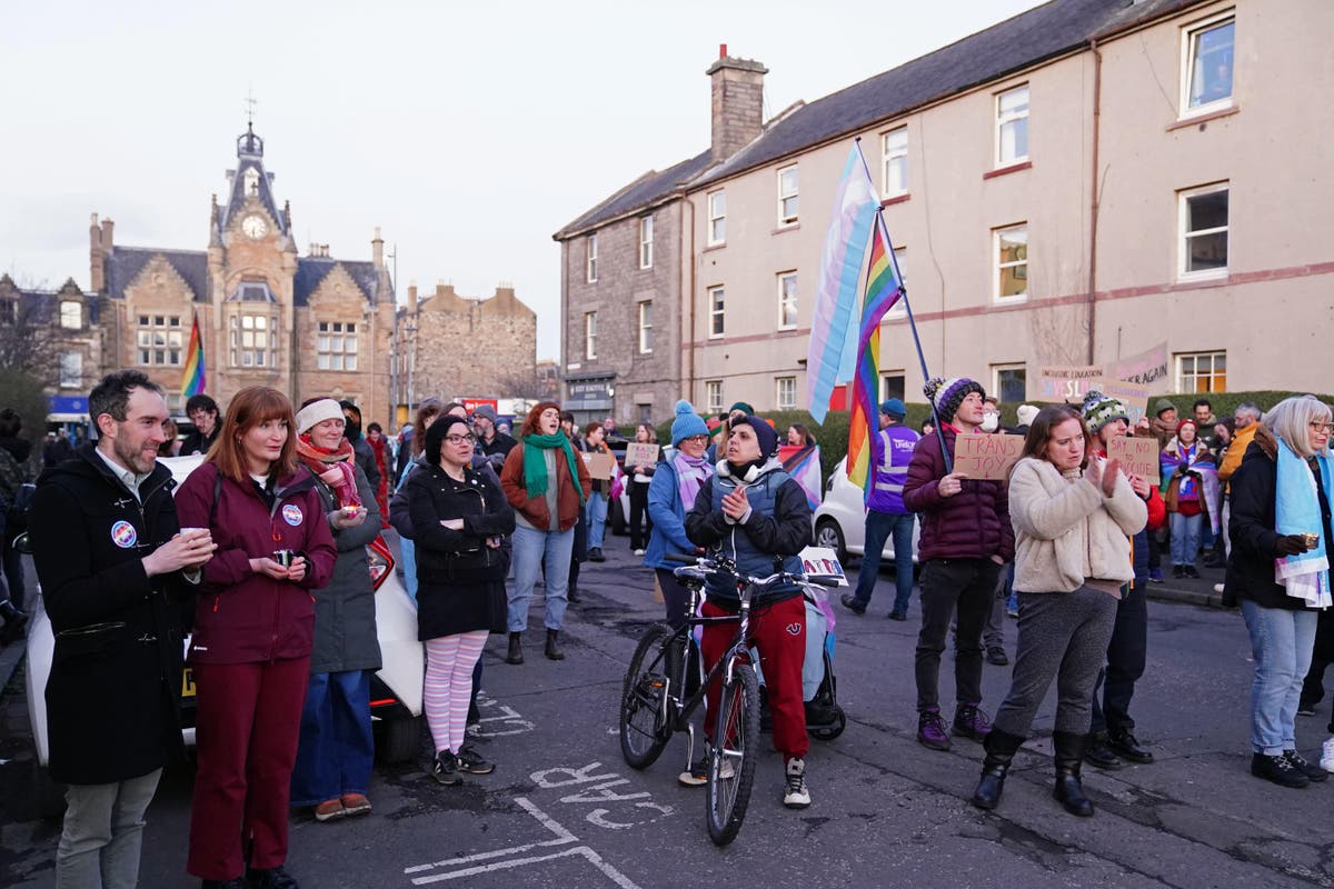 Protesters gather outside a library as parents discuss schools and gender identity