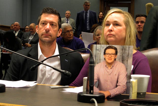<p>File - Stephen and Rae Ann Gruver with a photo of their son, Max Gruver, at a House committee room in Baton Rouge, La., in 2018.</p>