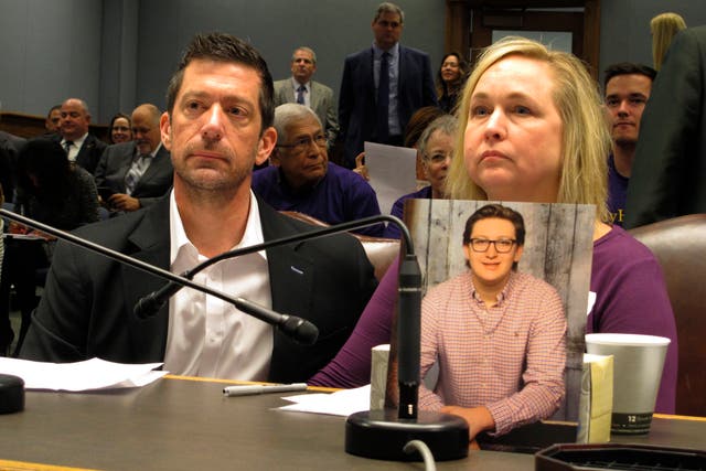 <p>File - Stephen and Rae Ann Gruver with a photo of their son, Max Gruver, at a House committee room in Baton Rouge, La., in 2018.</p>