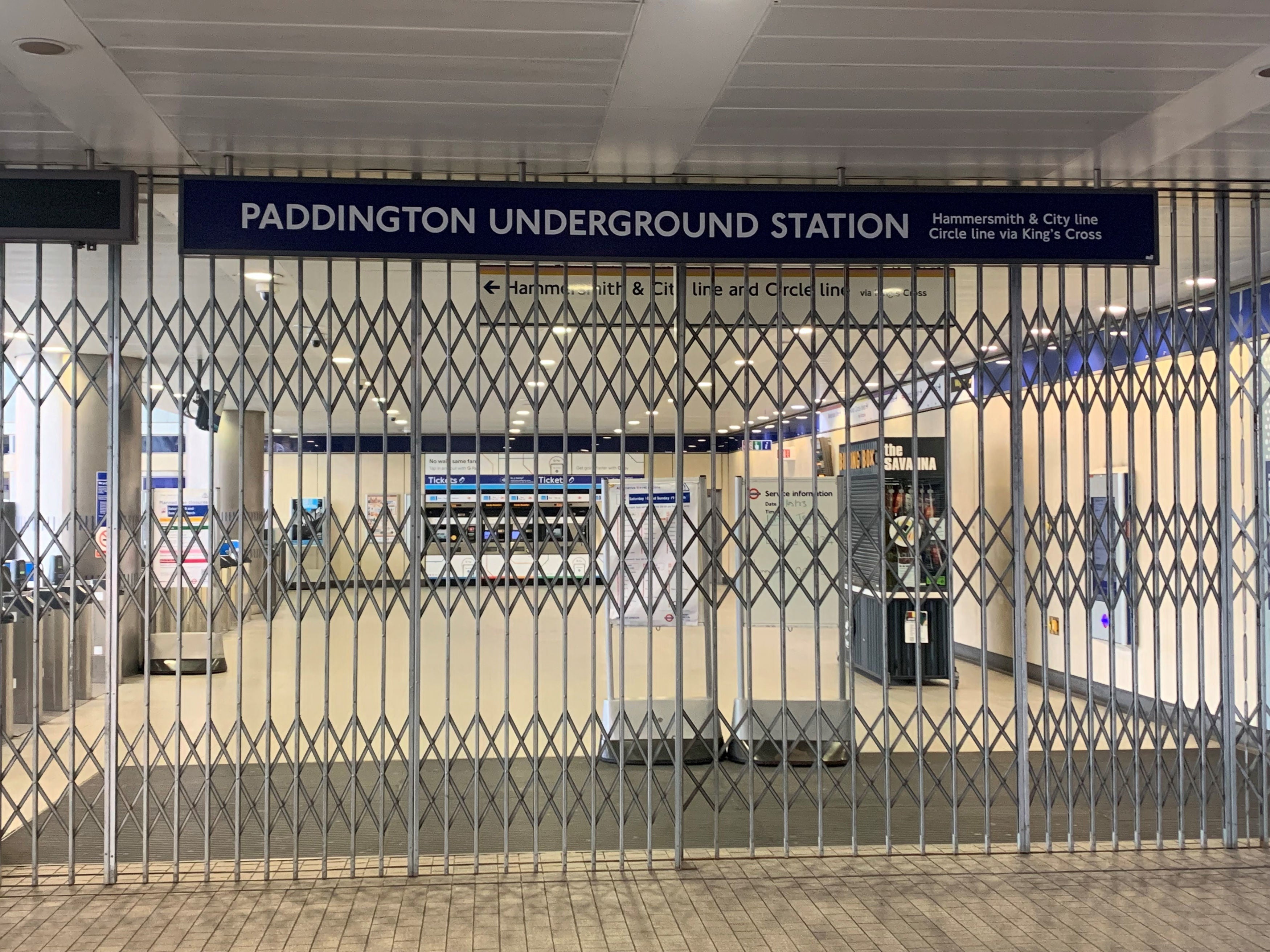 <p>Closed gates at London’s Paddington underground station, as strike action closes the entire TfL network</p>