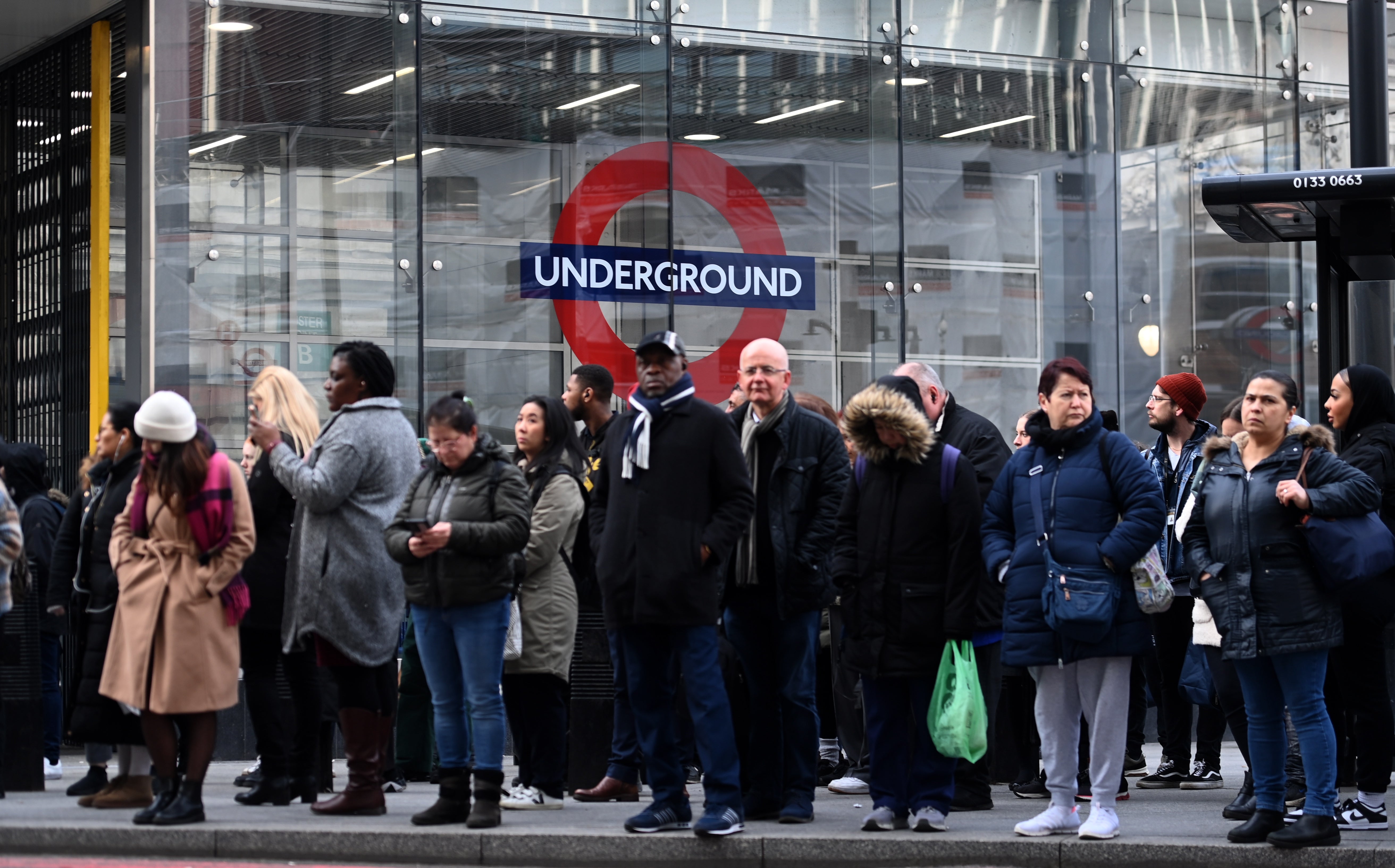 People queue for buses outside Victoria train station in London on Wednesday 15 March