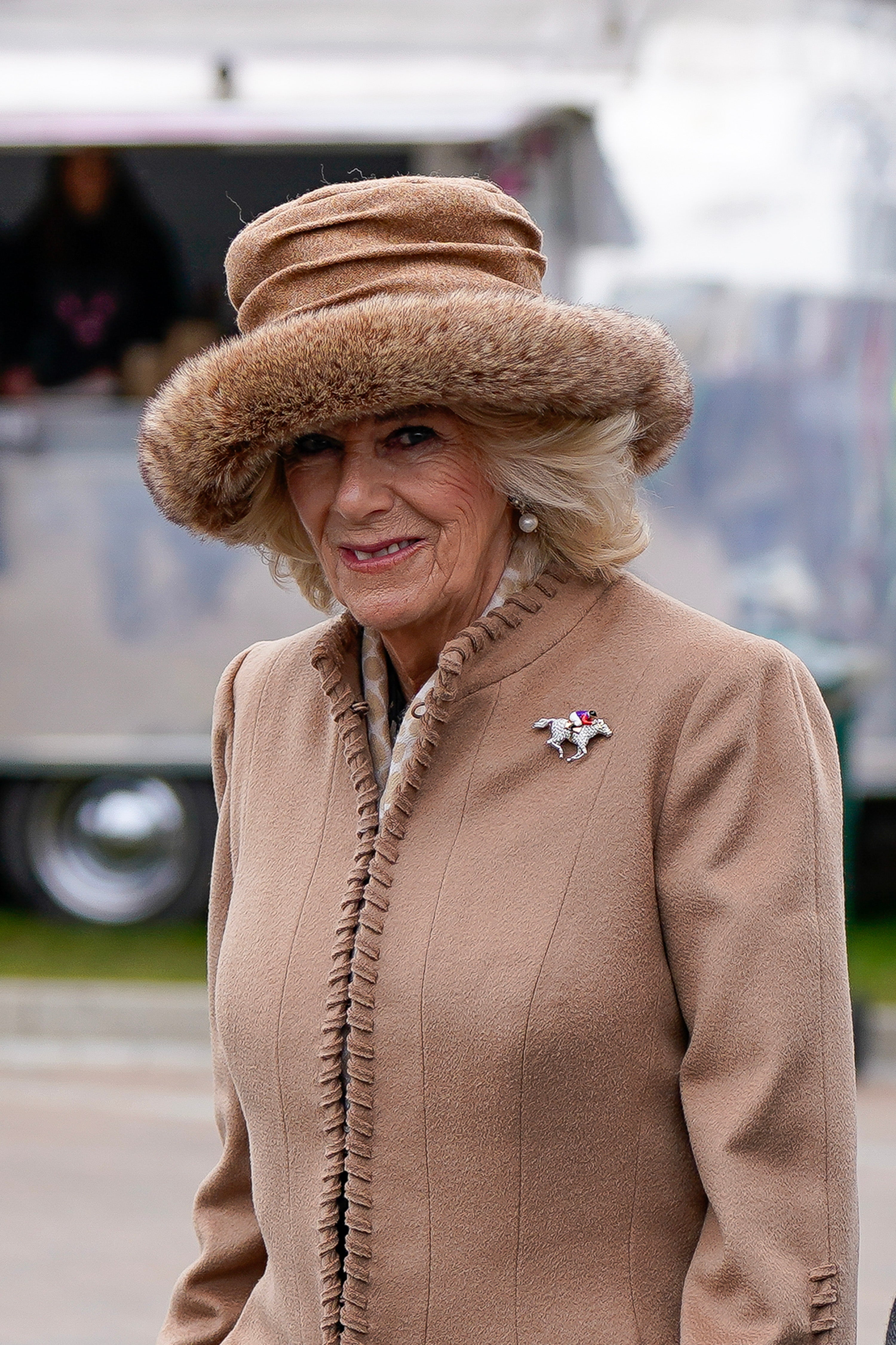Camilla Queen Consort arrived at the racing event wearing camel-coloured ensemble