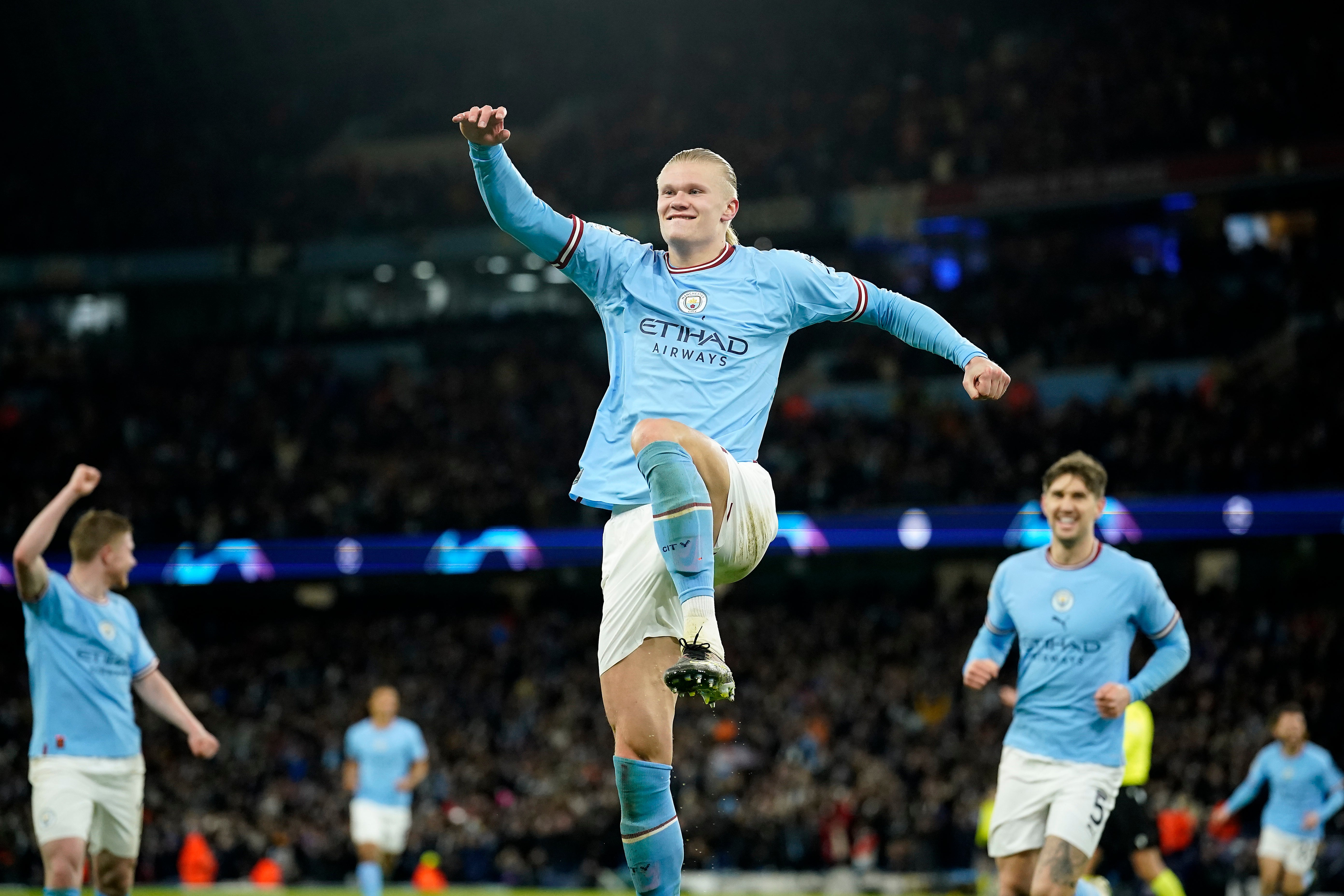 Erling Haaland celebrates as John Stones looks on