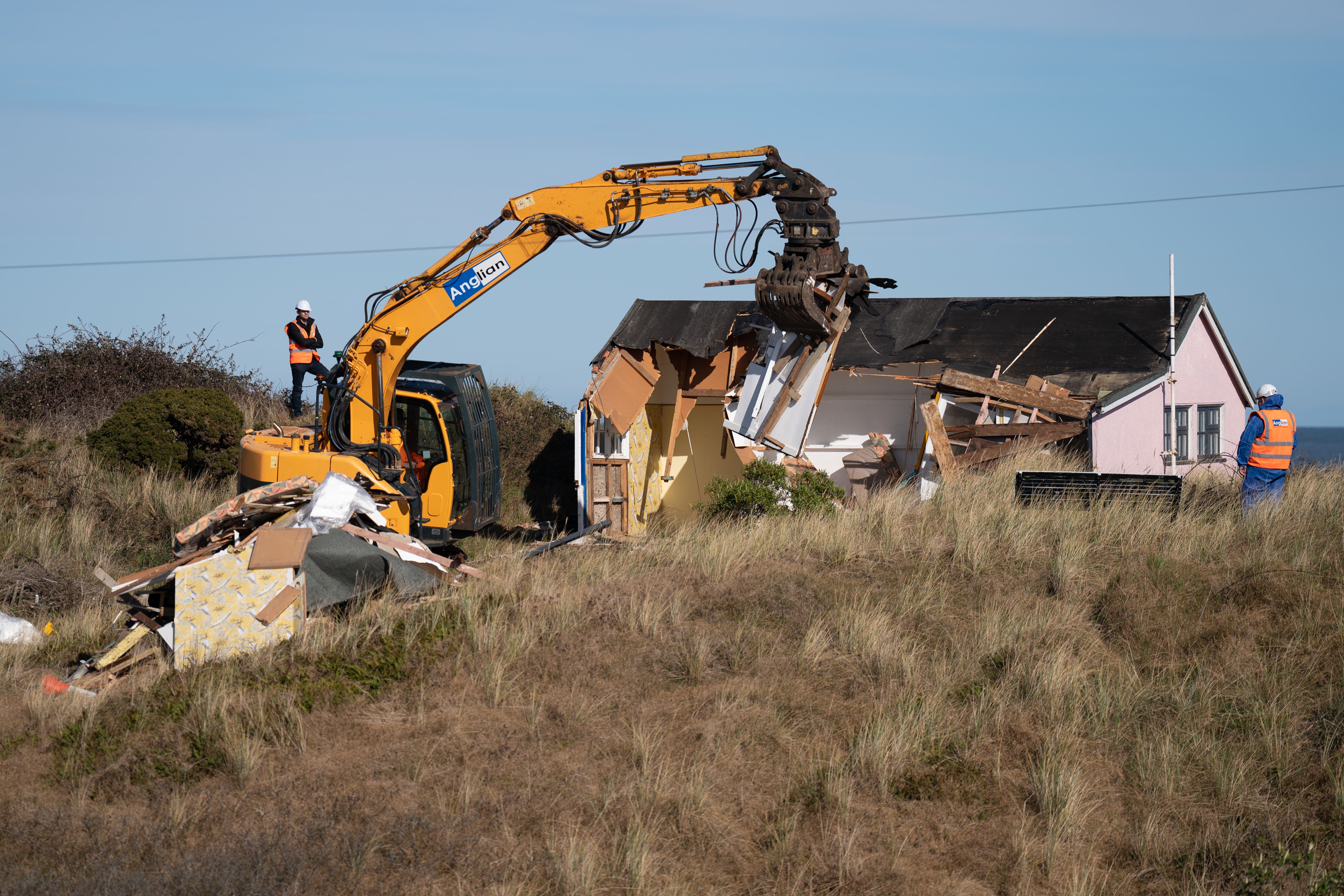 Three homes at risk of toppling into the sea in Norfolk were demolished over the weekend (Joe Giddens/ PA)