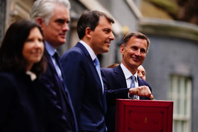 Jeremy Hunt (right) and Treasury ministers outside 11 Downing Street (Victoria Jones/PA)