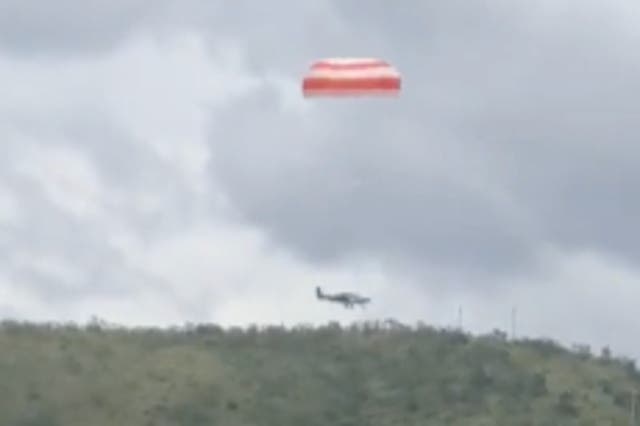 <p>A plane parachutes to safety in Brazil on 11 March, 2023</p>