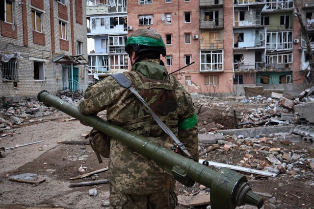 <p>Ukrainian soldier carries a portable anti-aircraft missile system in Bakhmut</p>