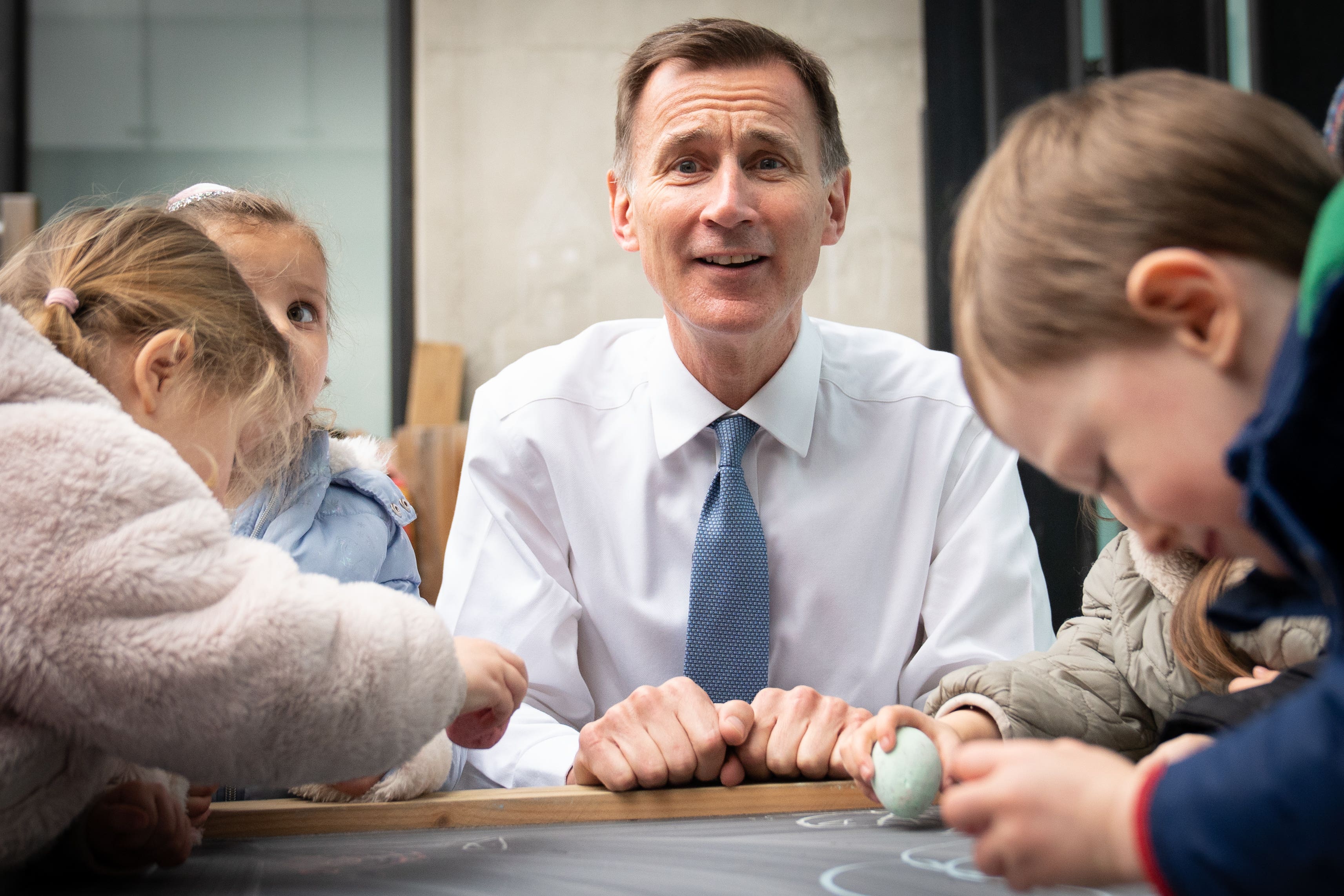 Jeremy Hunt met children during a visit to Busy Bees Battersea Nursery in south London after delivering his Budget