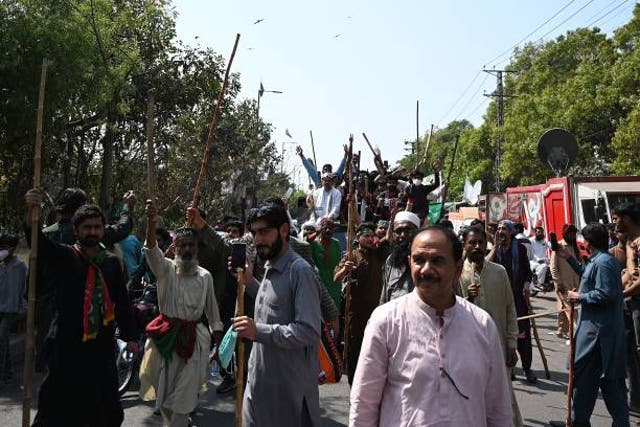 <p>Supporters of former Pakistan’s prime minister Imran Khan march towards Khan’s residence in Lahore on 16 March 2023</p>