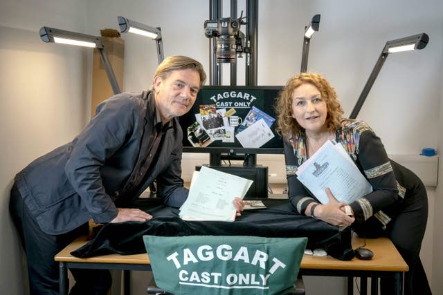 Taggart stars Blythe Duff and John Michie handing over scripts and memorabilia (GCU/PA)