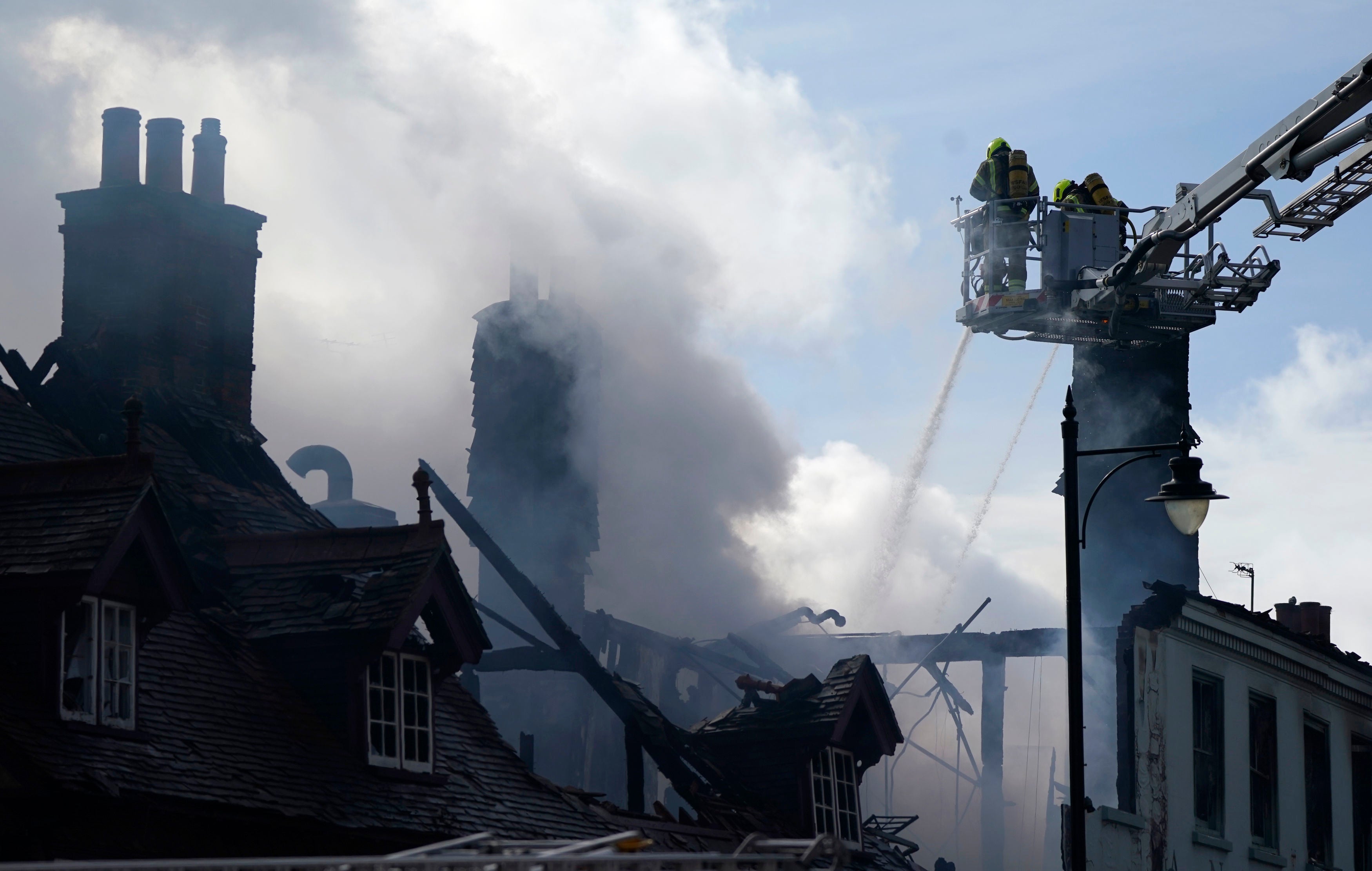 Firefighters dealing the remnants of the fire in the hours after the blaze