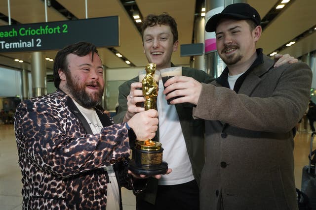 Actor James Martin, co-director Ross White and producer Pearce Cullen as the Oscar-wining team behind short film The Irish Goodbye arrives back at Dublin Airport (PA/Brian Lawless)