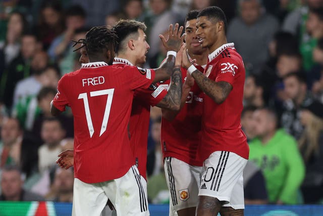 <p>Marcus Rashford celebrates with teammates after his goal won the game for United </p>