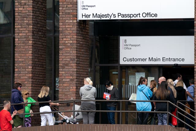 <p>People queue outside the passport office in Peterborough </p>