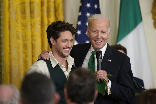 <p>Niall Horan with US President Joe Biden during a St Patrick’s Day Celebration reception (Niall Carson/PA)</p>