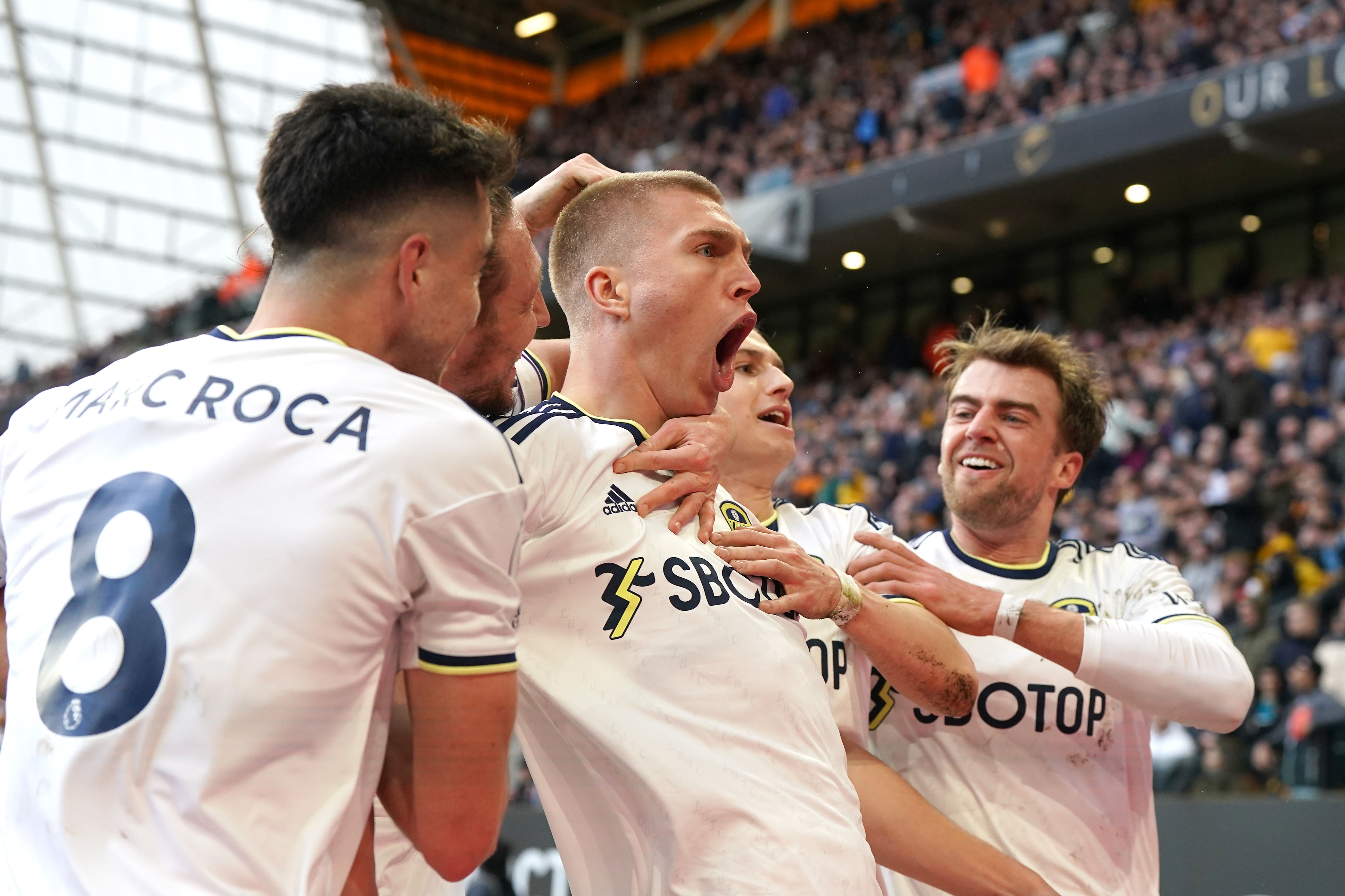 Leeds’ Rasmus Kristensen, centre, celebrates his goal (Nick Potts/PA)