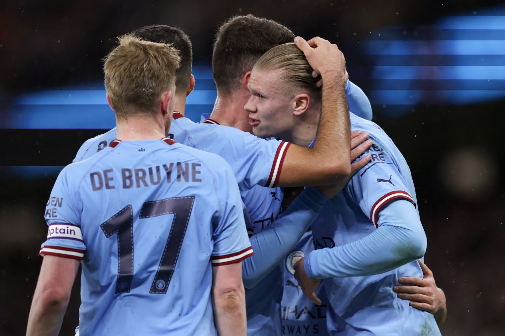 Haaland celebrates with teammates after scoring the first of his hat-trick