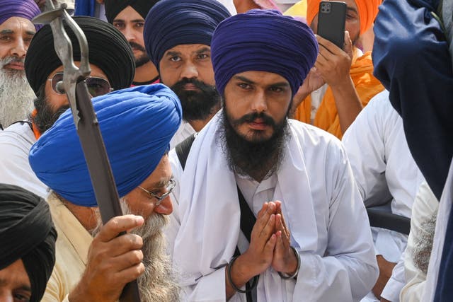 <p>File image:  Chief of a social organisation, Amritpal Singh (C) along with devotees takes part in a Sikh initiation rite ceremony</p>