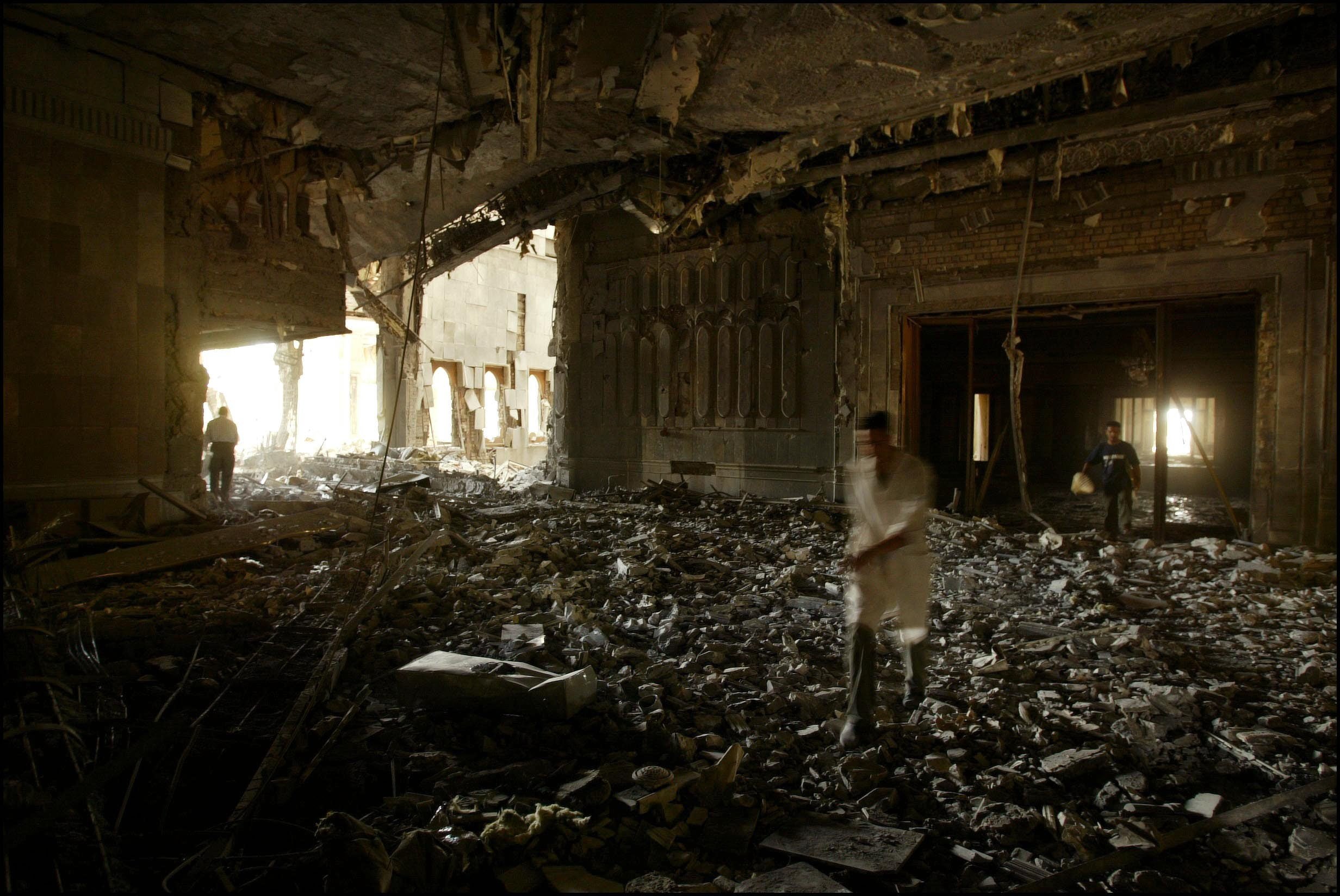 People in the damaged presidential palace of Saddam Hussein on 12 April, 2003