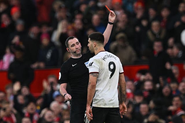 <p>Aleksandar Mitrovic confronts referee Chris Kavanagh during the FA Cup tie at Old Trafford</p>