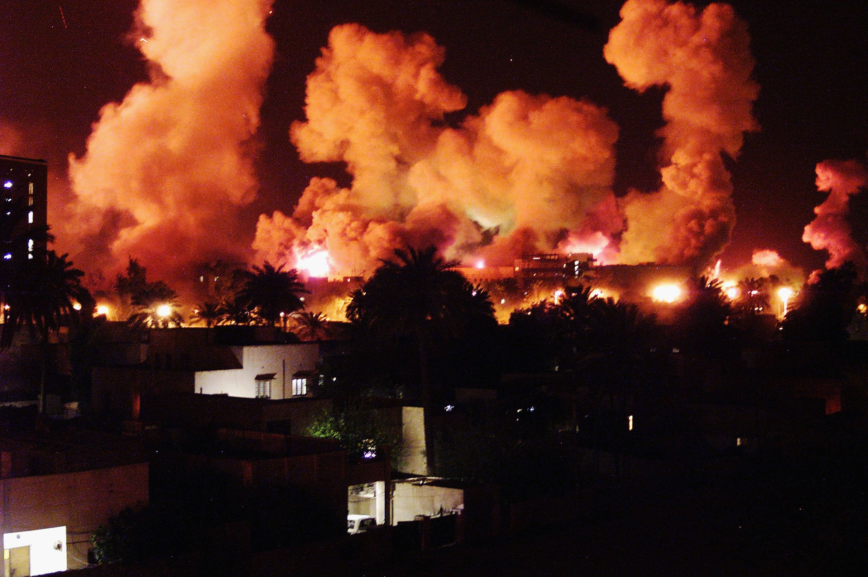 <p>Smoke rises from explosions in Baghdad during the first few minutes of an air attack on 21 March, 2003</p>