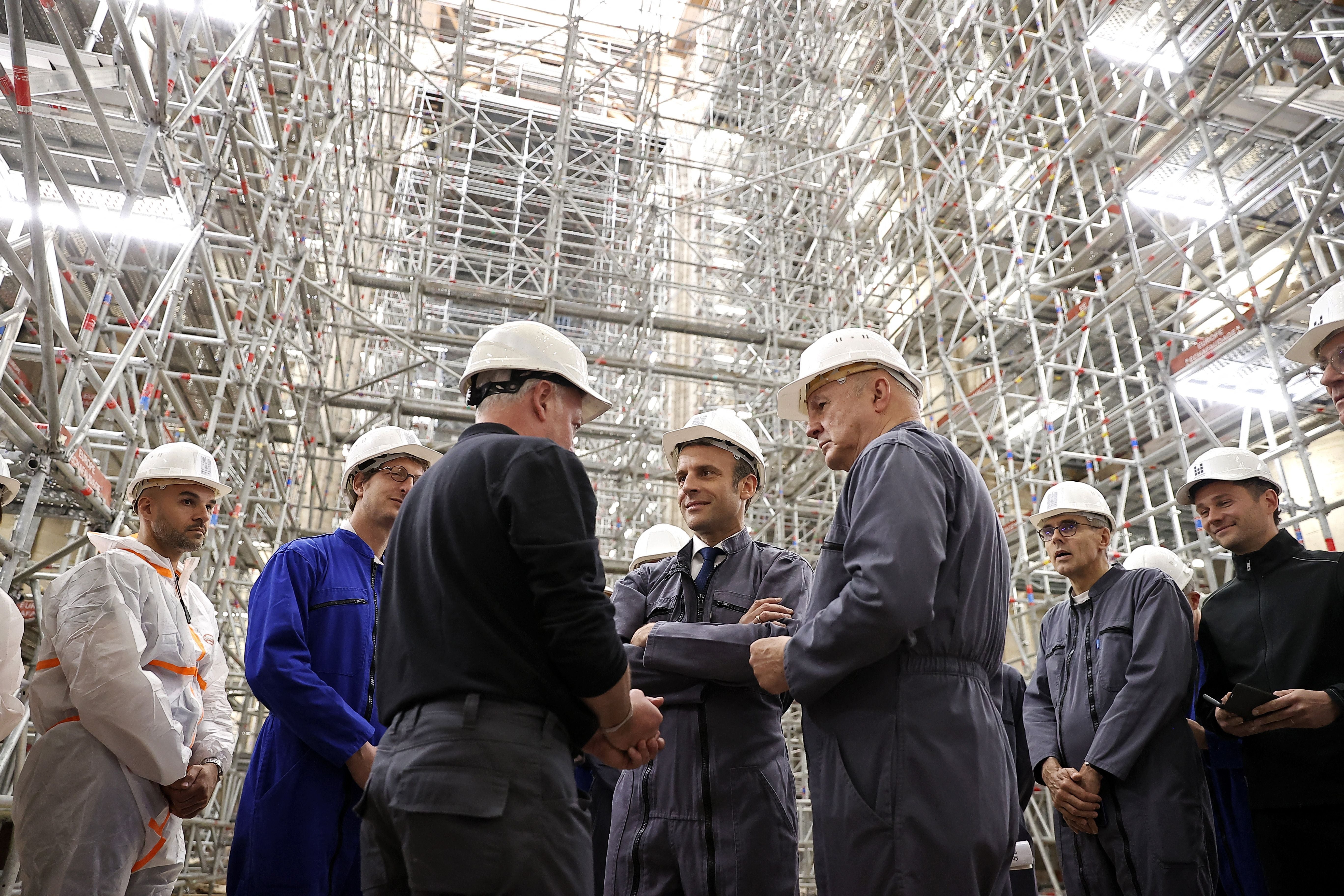 Macron (centre) has vowed to restore the monument