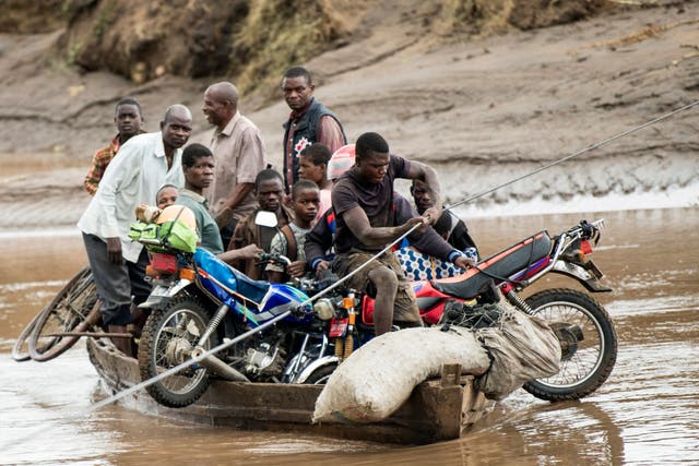 <p>Men transport their salvaged belongings in Chiradzulu, southern Malawi</p>