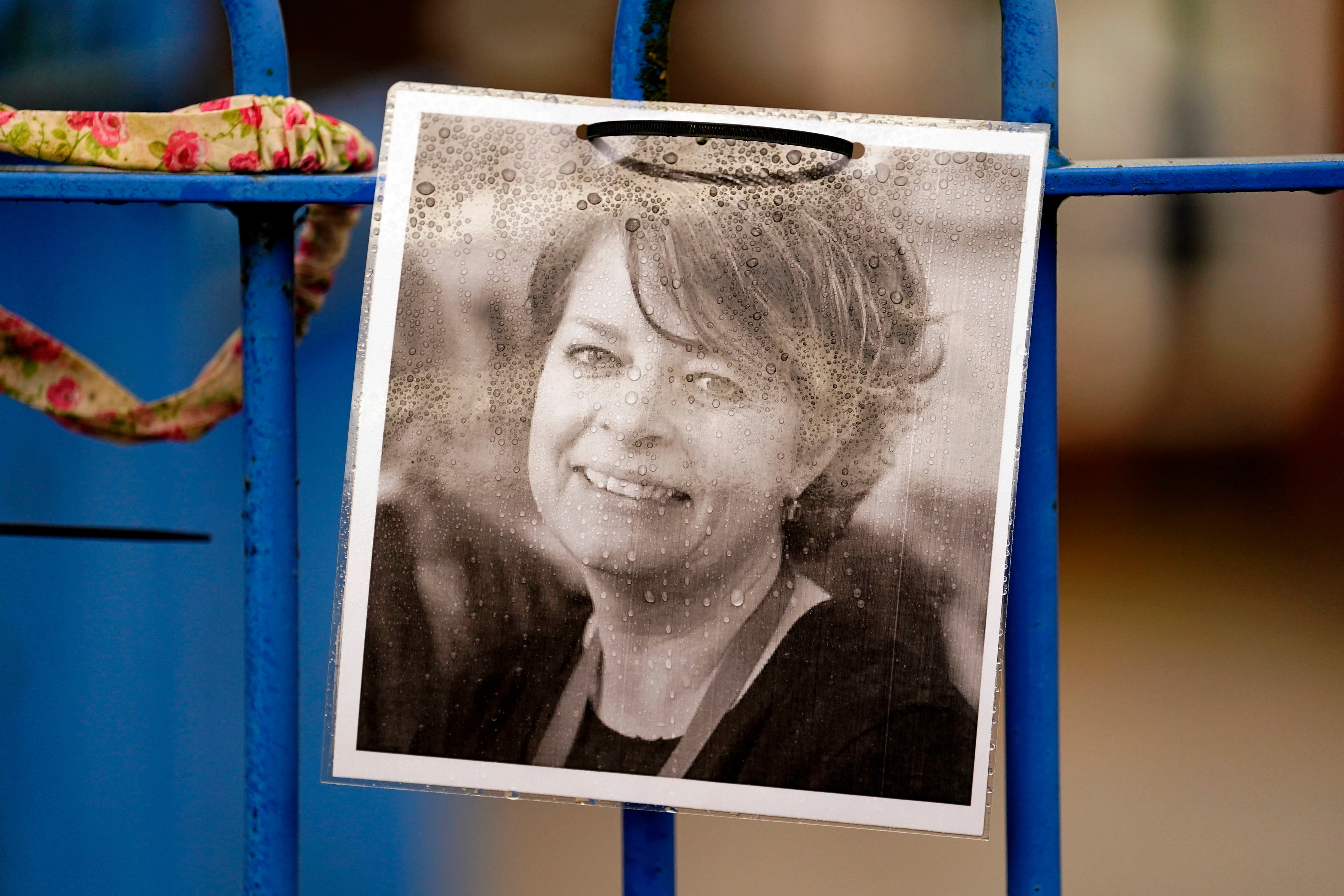 A photograph of Ruth Perry attached to the fence outside John Rankin Schools