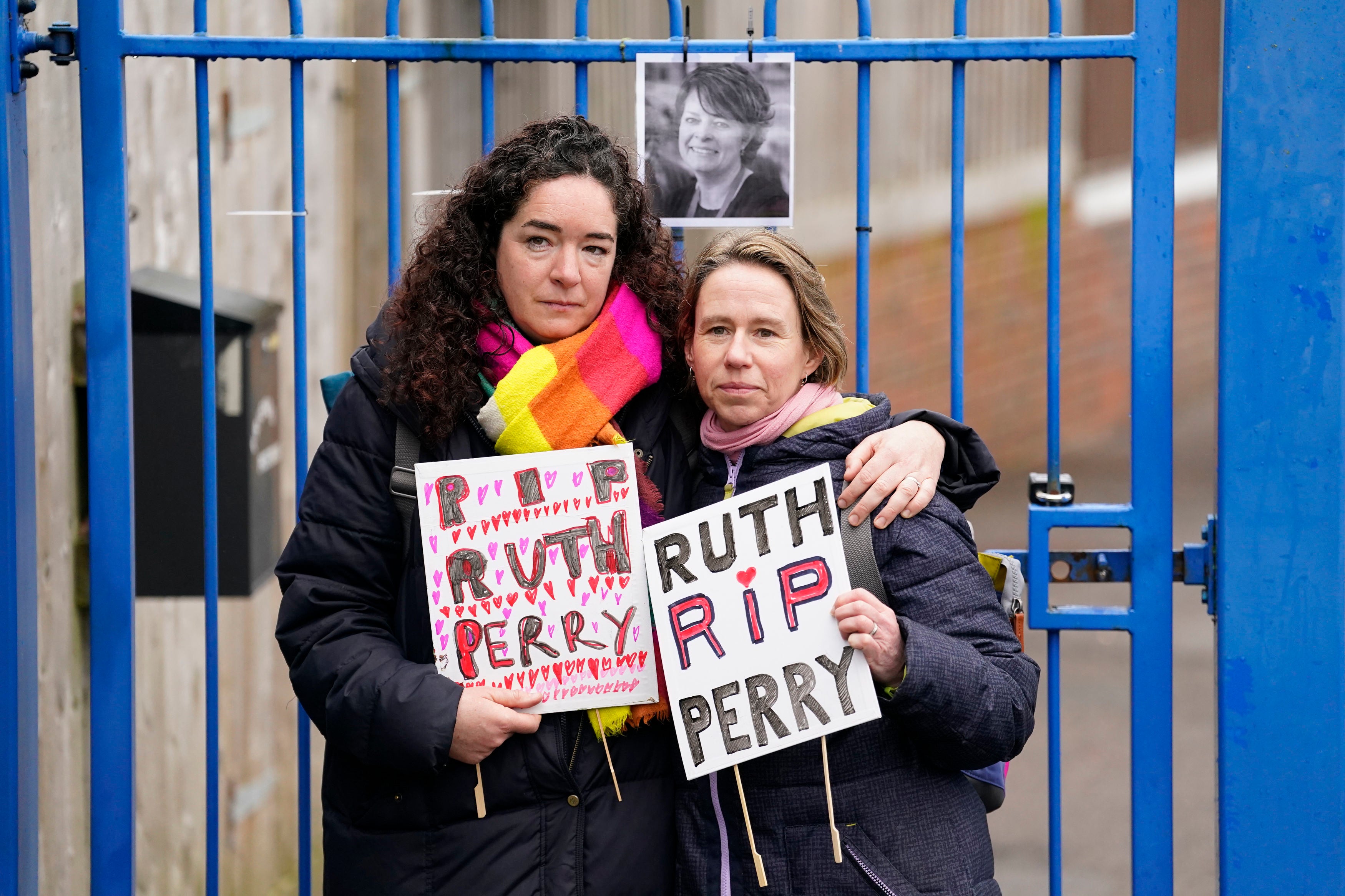 Two demonstrators mourn Ruth Perry outside the gates to John Rankin Schools in Newbury, Berkshire