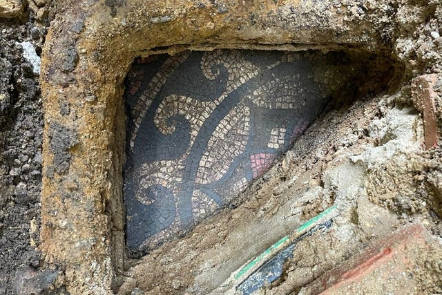 Work has started to unearth a Roman mosaic buried under a pavement outside a vape shop in Colchester in Essex (Martin Leatherdale/PA)