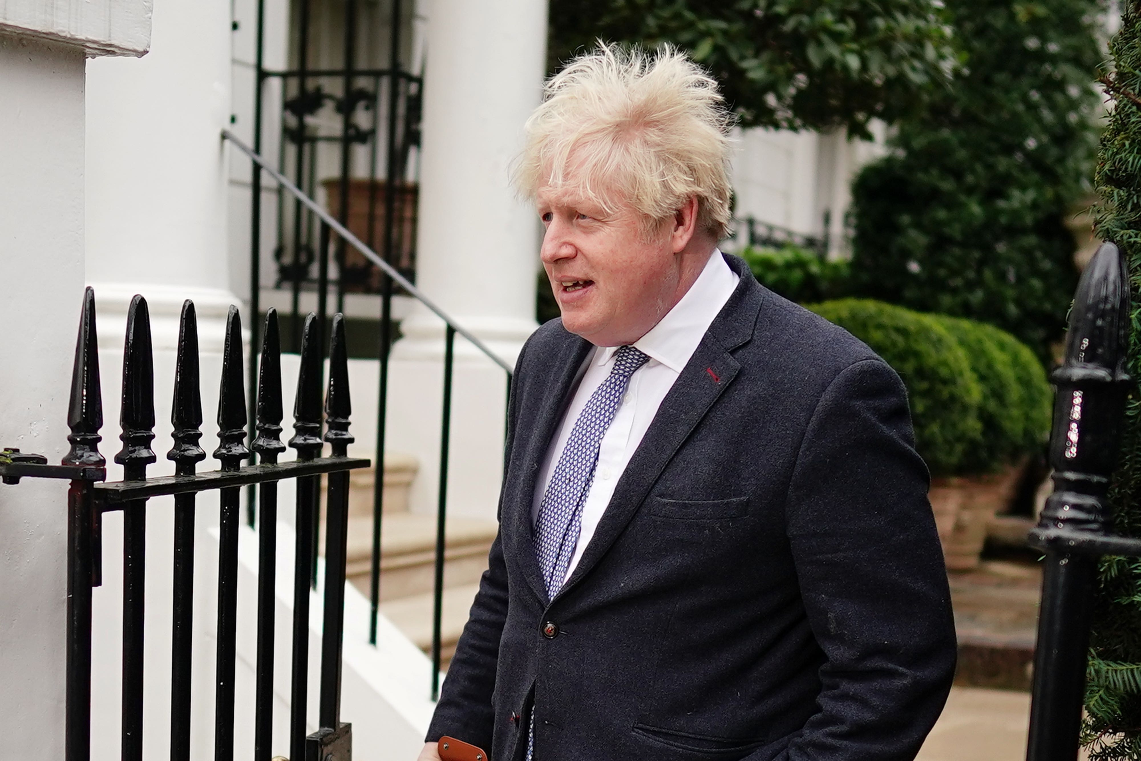 The former prime minister Boris Johnson leaves his home in London on Tuesday