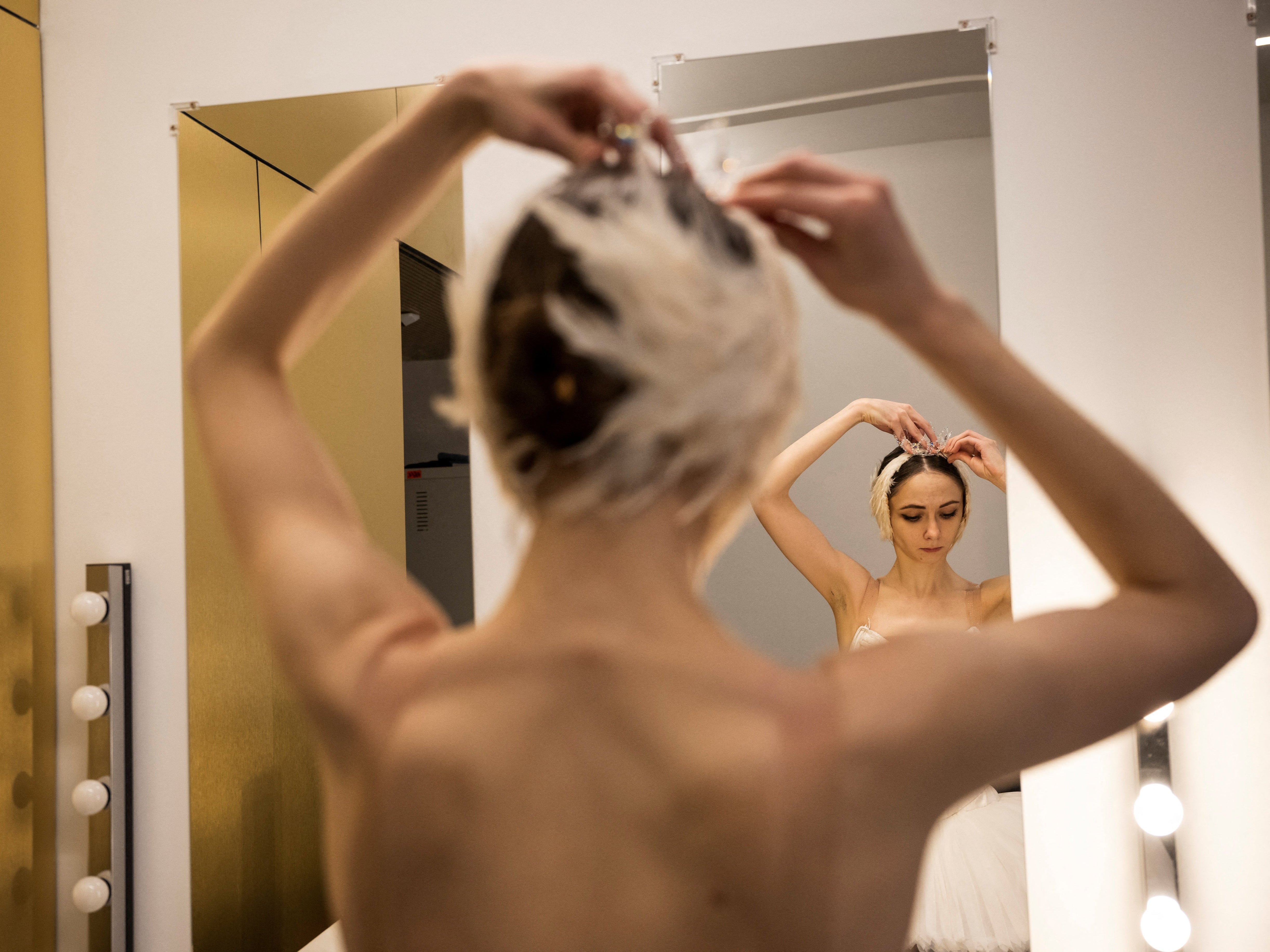 Ganna Muromtseva tries on her headdress after a stage rehearsal