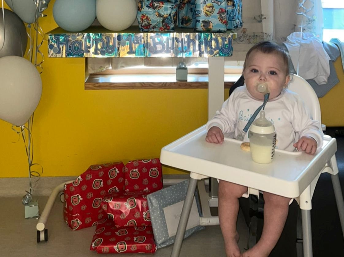 Baby boy Bailey Kilbane sits at high chair in hospital