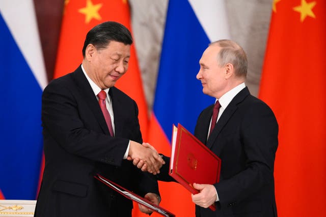 <p>Russian President Vladimir Putin and Chinese President Xi Jinping following talks in Moscow (Vladimir Astapkovich/Sputnik/AP)</p>
